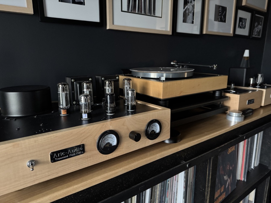 Rick’s listening setup — a turntable and tube amplifier on a shelf above his records